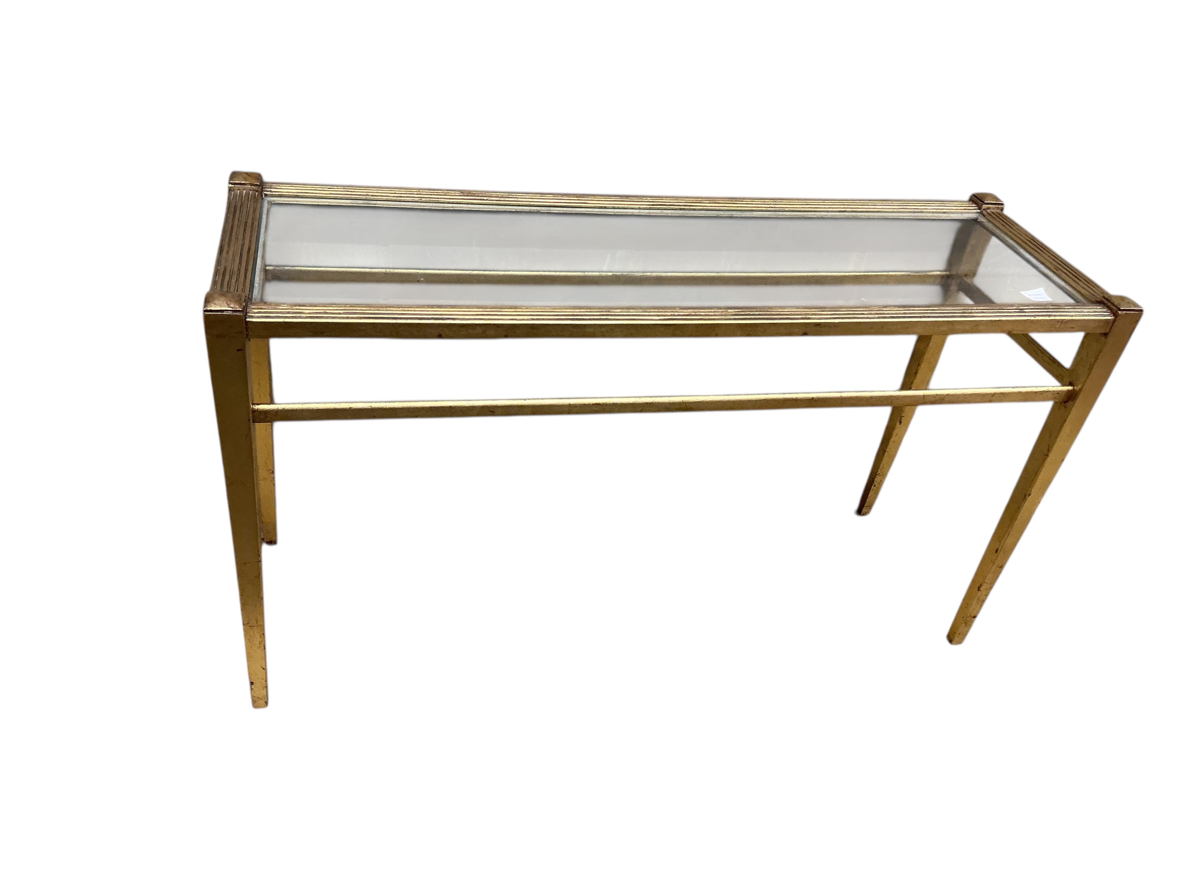 A reproduction gilt composition glass top console table, width 138cm, depth 46cm, height 78cm and a mirror
